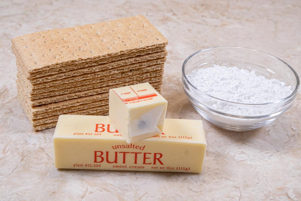 The ingredients for the graham cracker crust are unsalted butter, graham crackers and powdered sugar. 