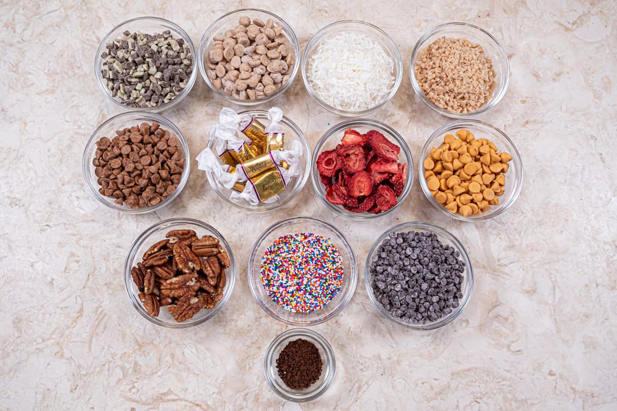 Toppings for the donuts include Andes mints, peanut butter chips, coconut, brickle, cinnamon chips, caramels, freeze dried strawberries, pecans, butterscotch chips, nonpareils, mini chocolate chips, and instant coffee.