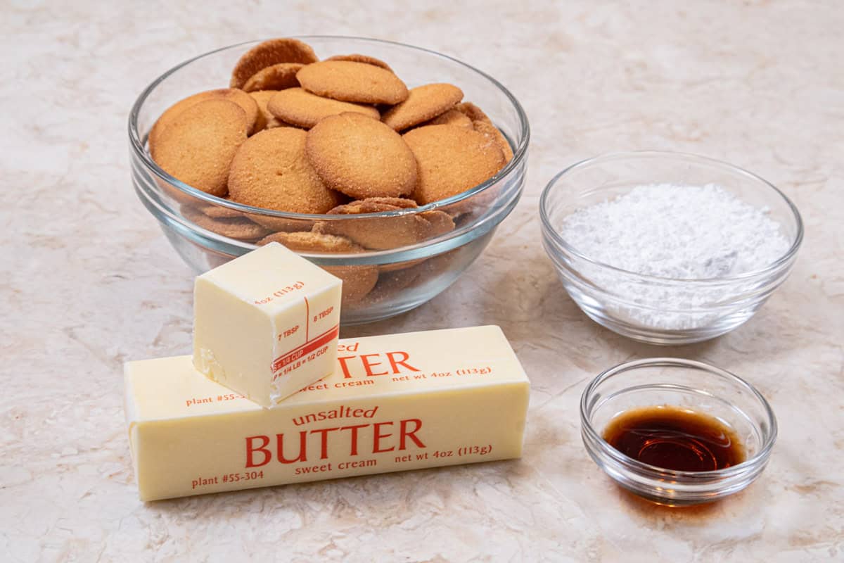 Ingredients for the crust of the No Bake White Chocolate Cheesecake include vanilla wafers, powdered sugar, vanilla, and unsalted butter.