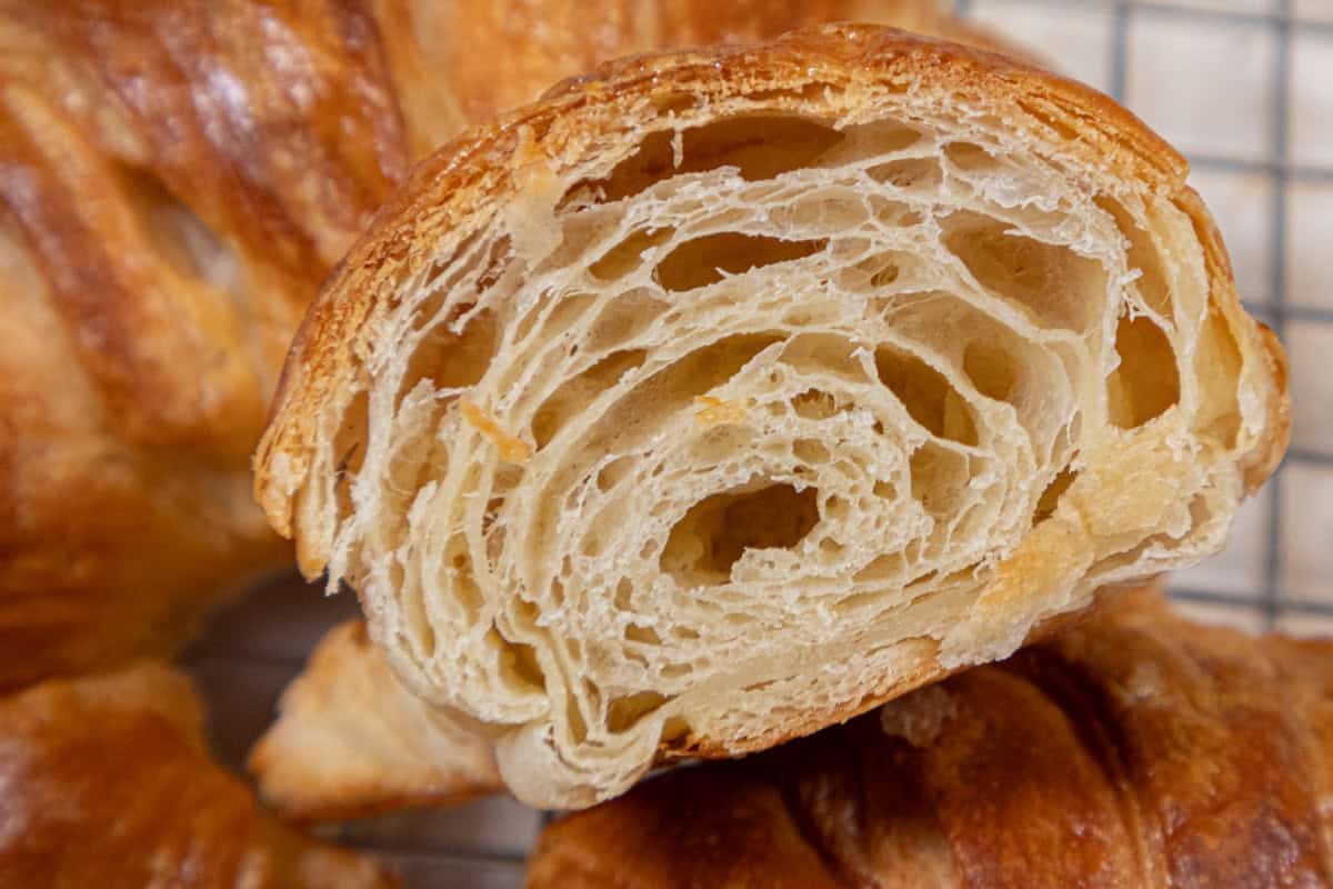 A view of the cut croissant showing the many layers after baking.