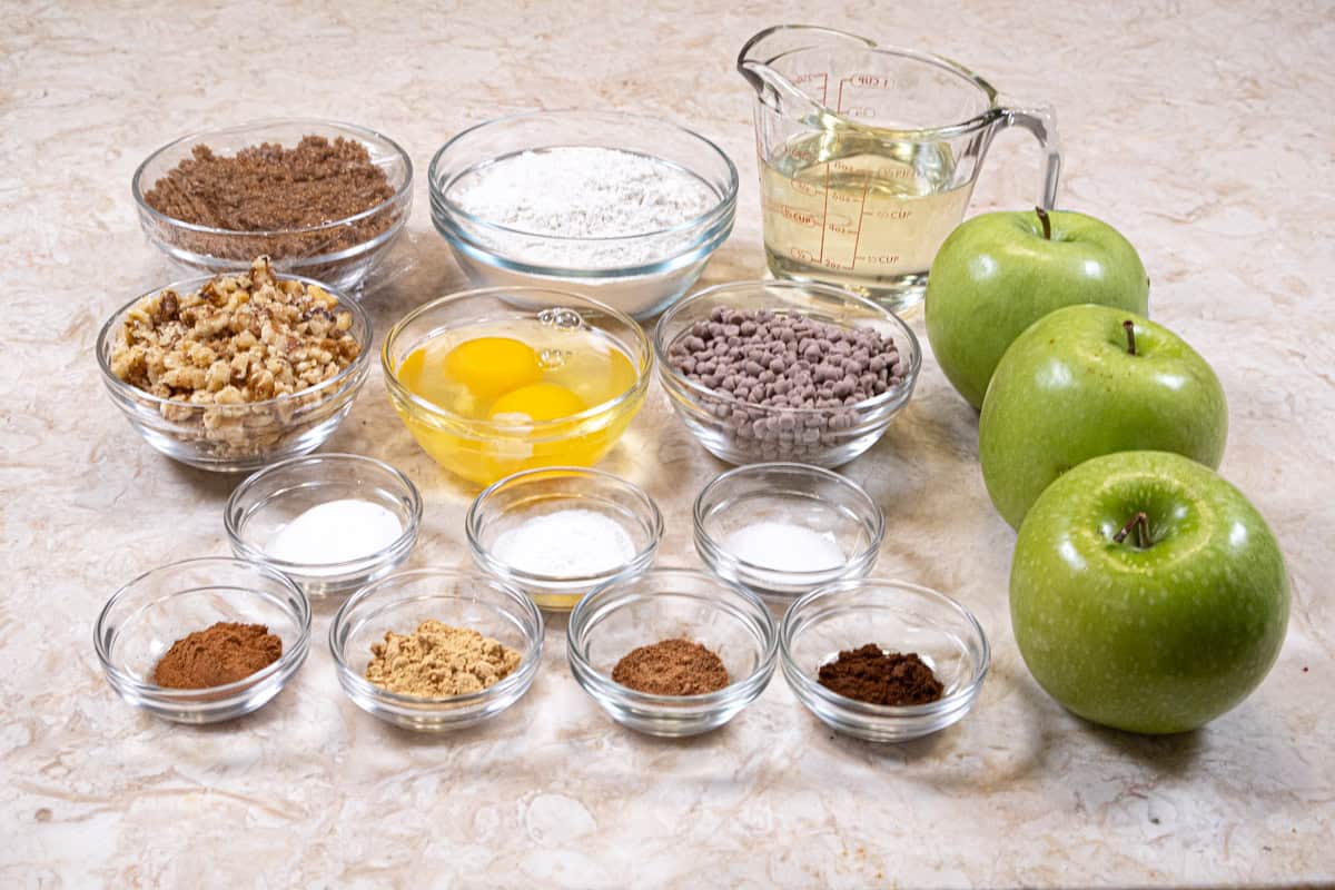Ingredients for the Apple Spiced cupcakes include all-purpose flour, baking powder, baking soda, salt, brown sugar, canola or vegetable oil, eggs, apples cinnamon, ginger, cloves, nutmeg walnuts and cinnamon chips. 