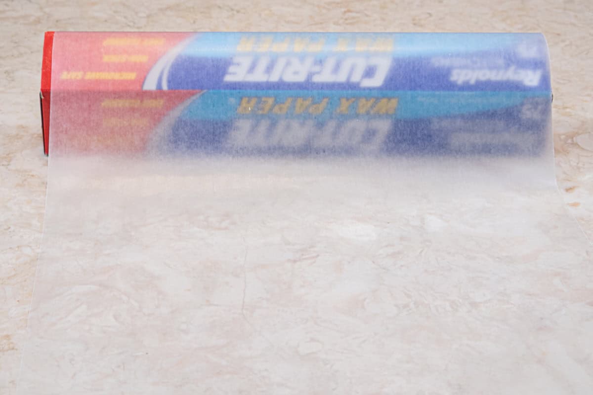 A box of waxed paper with some of it unrolled. 